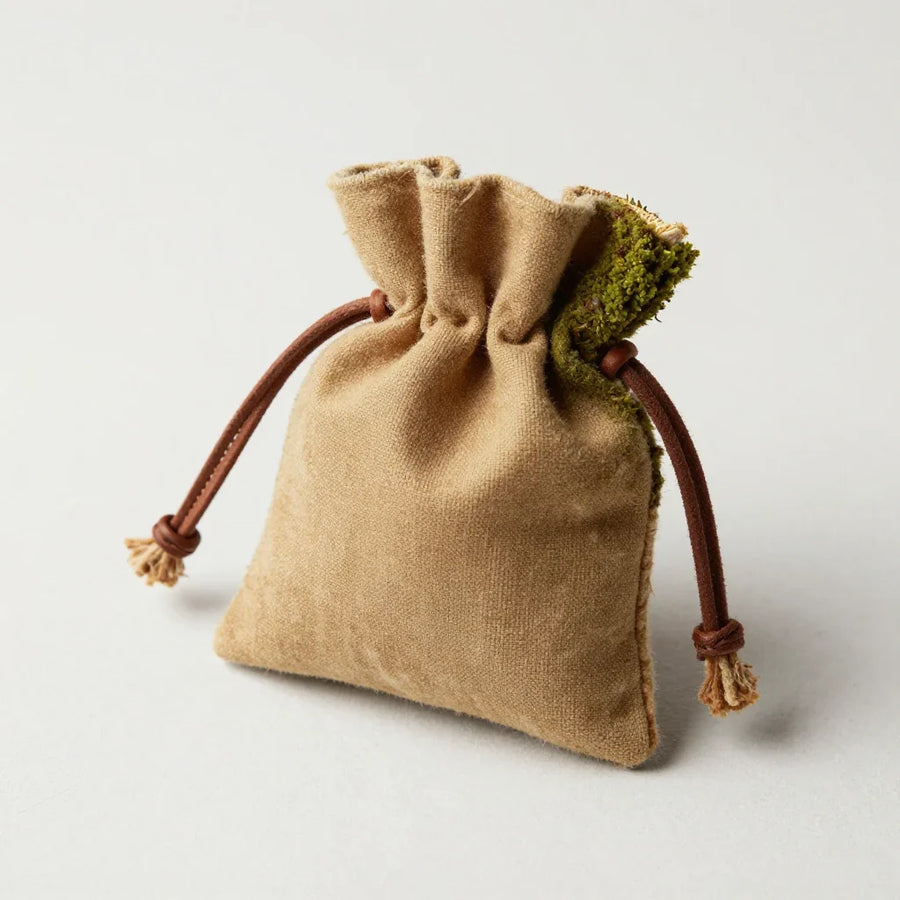 Pilgrim Pouch by ALPORA, a compact wrapped pouch in yak wool and waxed canvas, translating the tibetan pilgrim's cloth bundle for daily carry