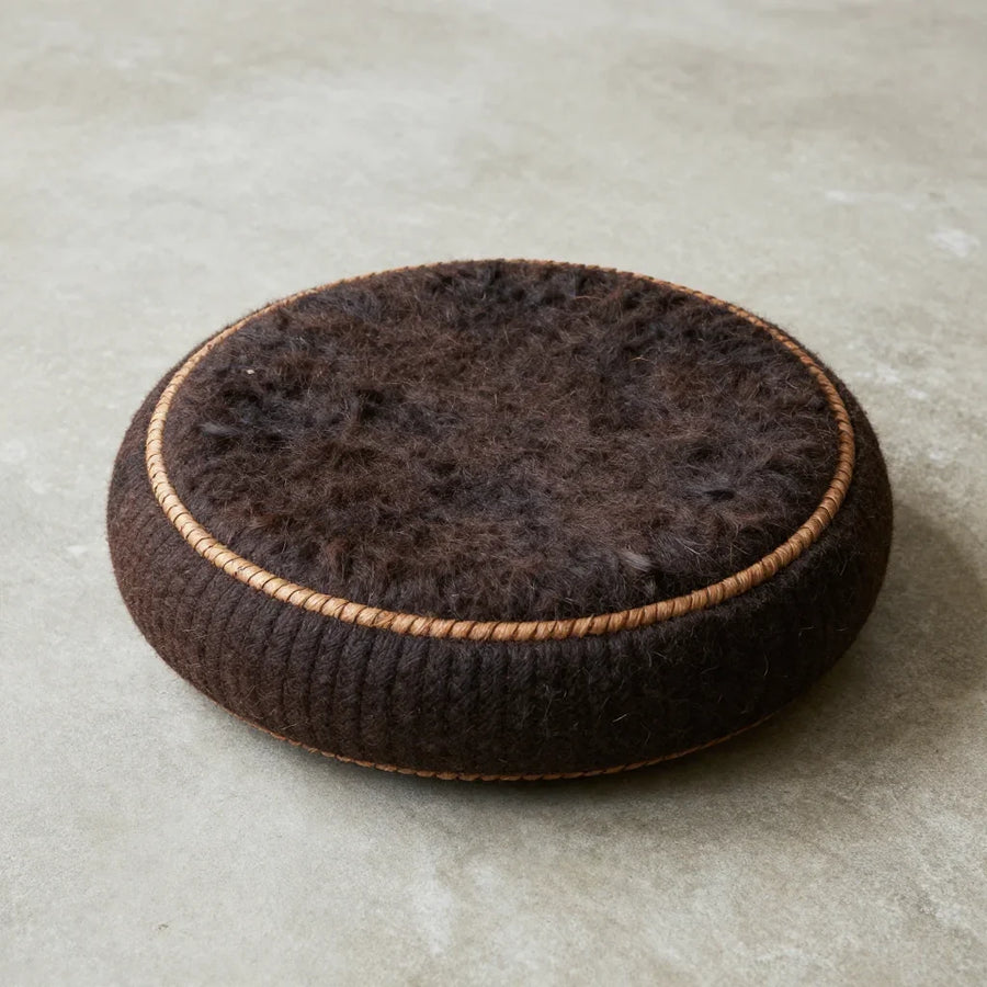 Driza Saddle Cushion by ALPORA, a round saddle-style cushion handwoven from natural yak hair and wool, translating the tibetan nomadic saddle pad into a contemporary seat