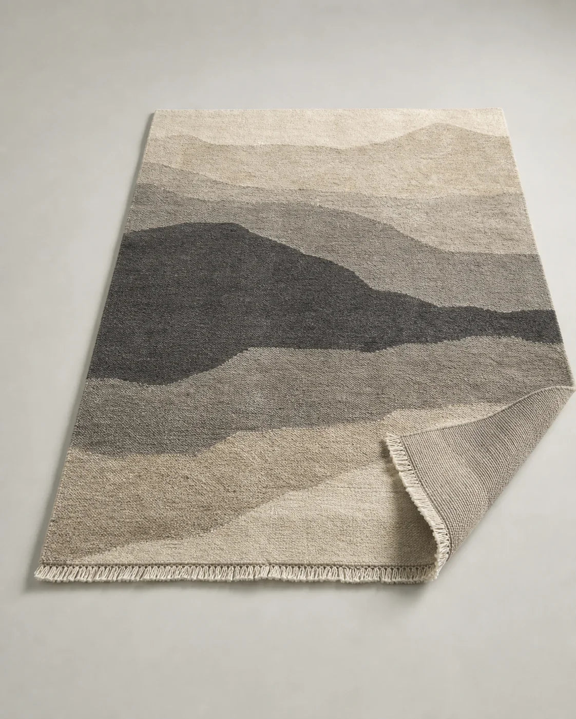 Moraine Handknotted Wool Rug by ALPORA, a large-format natural wool rug with mineral layers and a deep charcoal field