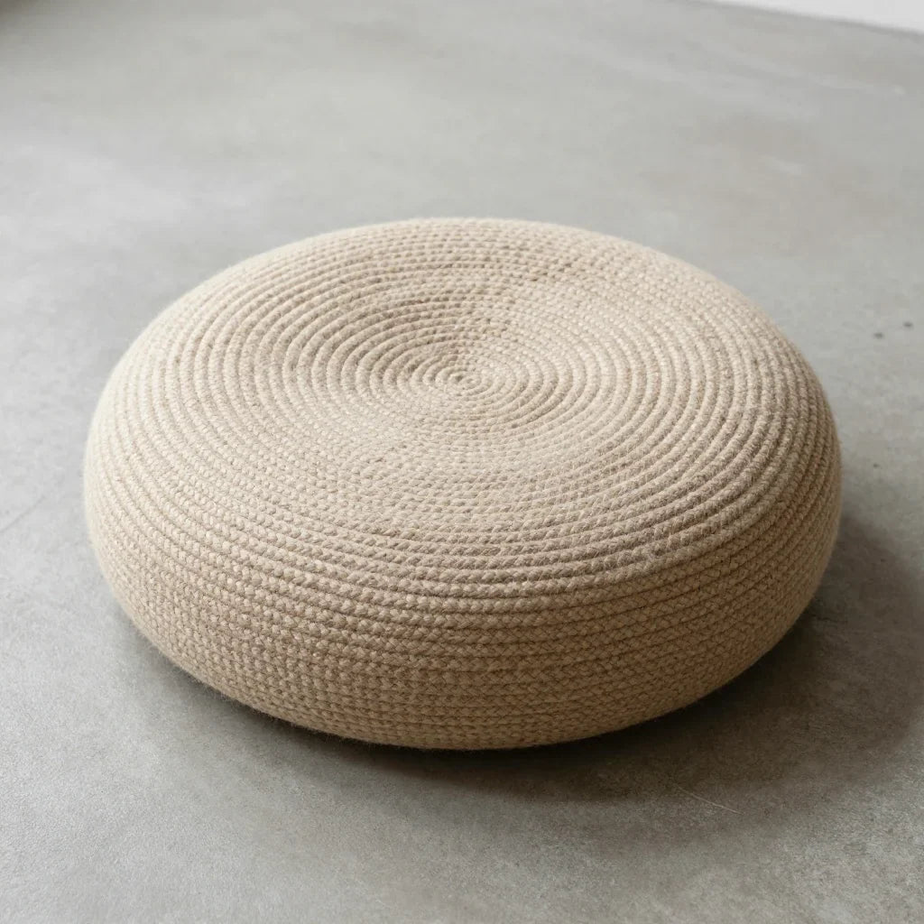 Zafu Meditation Cushion by ALPORA, a round, handwoven zafu in undyed natural wool for seated meditation and quiet reflection